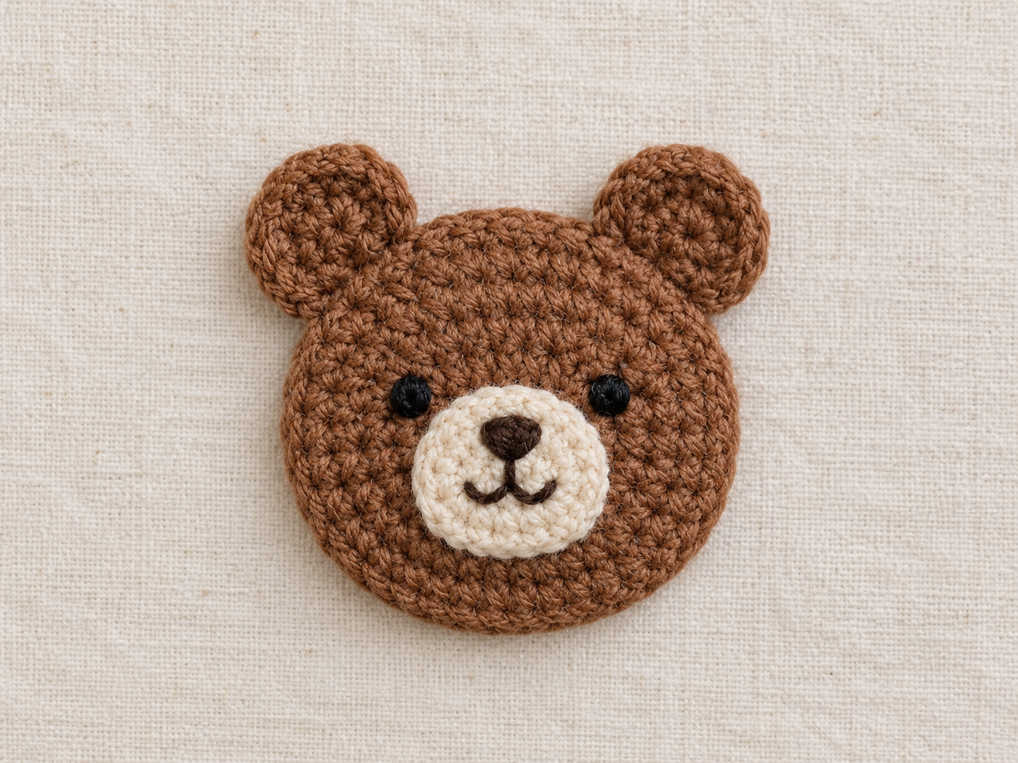 Brown crochet bear appliqué with cream muzzle